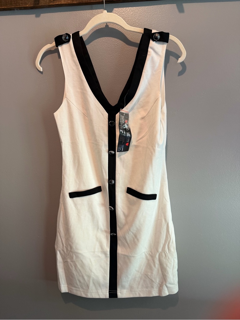 Sleeveless Cream Mini Dress with Black Trim and Button Front